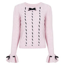 Blush pink cable-knit sweater with black velvet ribbon and bows