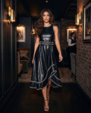 Model wearing the black leather-look whipstitch belted midi dress
