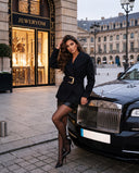 Model wearing the black belted jacket with gold buckle