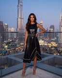 Model wearing the black leather-look whipstitch belted midi dress